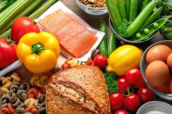 Healthy food ingredients including salmon, vegetables, grains and artisan bread for nutritional therapy and wellbeing