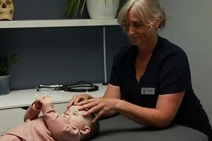 Osteopath performing treatment on baby in clinic